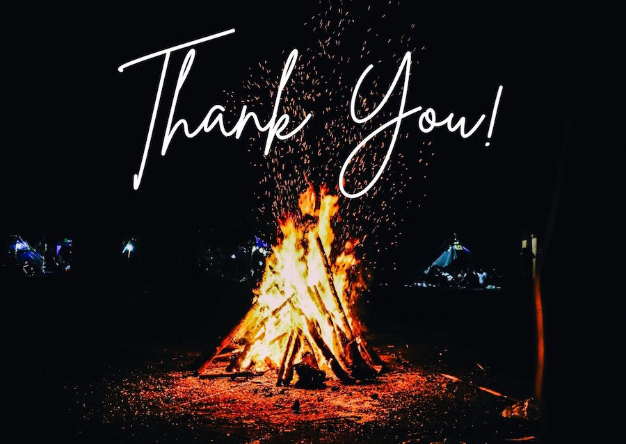 A bonfire on a dark beach. The words "Thank you!" are written on top
